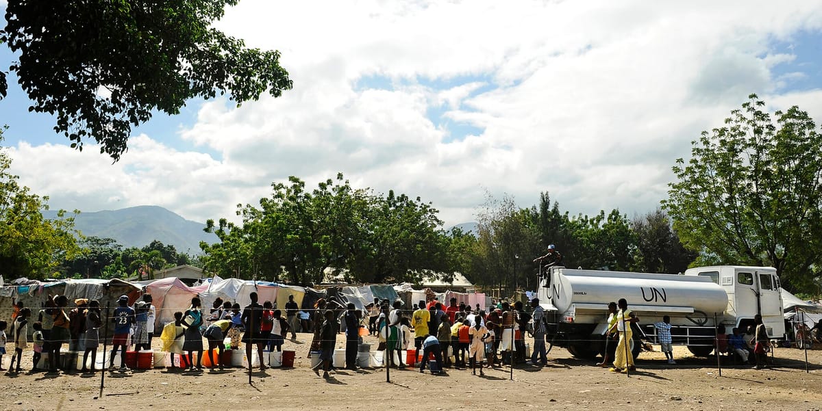 Jan. 25, 2010. Displaced Haitians wait in line for fresh drinking water from a United Nations water truck at the Lifeline Christian Ministries Mission in Grand Goave, Haiti.